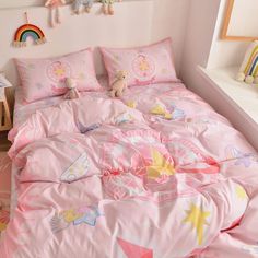 a child's bedroom with pink bedding and toys