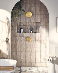 a bath room with a toilet and a shower head mounted to the side of a wall