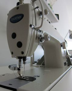 a white sewing machine sitting on top of a table