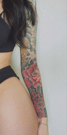 a woman with tattoos on her arm and thigh