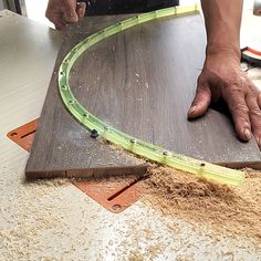 a man is working on a piece of wood that has been cut into smaller pieces