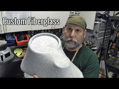 a man is holding a large white object in his hand with the words custom fiberglass on it