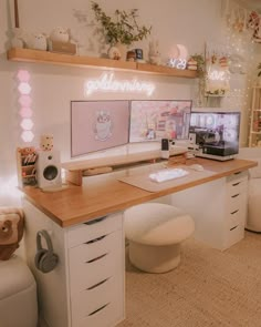 a desk with two computer screens on it in a room filled with furniture and decorations