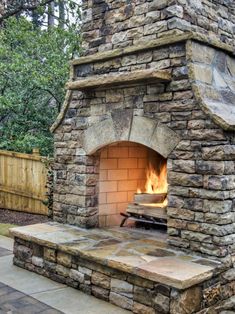 an outdoor brick oven with fire in it