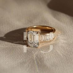 an engagement ring with three baguets on it