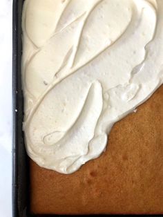 a cake with white frosting in a pan