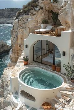 an outdoor jacuzzi tub on the side of a cliff