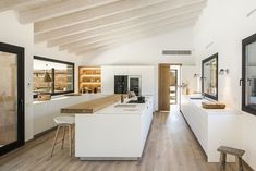 an open kitchen with white cabinets and wood flooring is featured in the video's ad