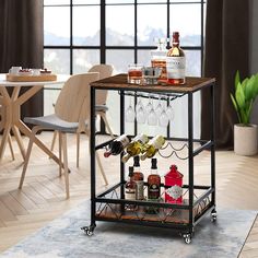 a bar cart with bottles and glasses on it