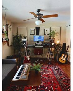 a living room filled with lots of furniture and a guitar sitting on top of a rug