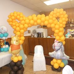 winnie the pooh balloon arch in an office