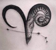 a black and white photo of a ram tattoo on the back of a woman's stomach