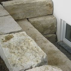 a fire place sitting next to a pile of rocks on the side of a building