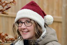 a woman wearing glasses and a knitted hat