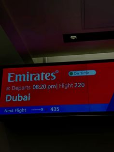 an airport sign with emirates's departure information on it