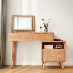 a wooden desk with drawers and a mirror