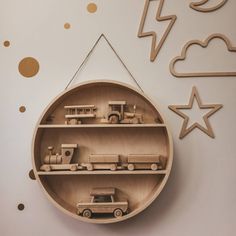 a wooden shelf with toy cars and trucks on it in the shape of a circle