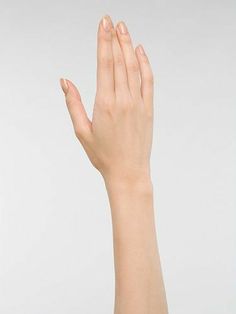 a woman's hand is reaching up into the air