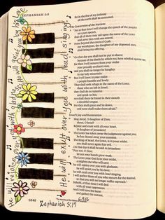 an open bible with flowers and piano keys