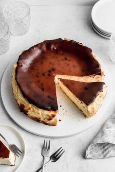 a chocolate cheesecake on a plate with a slice cut out