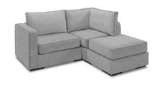 a sectional couch with pillows on it and a footstool attached to the back