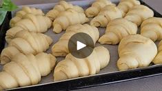 there are many croissants on the tray ready to be baked in the oven