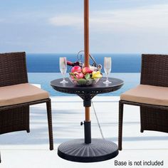 an outdoor table with two chairs next to it