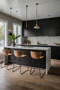 a kitchen with three bar stools next to an island