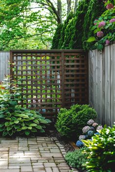 a brick path leads to a wooden fence and shrubbery in the back yard area