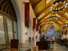 the inside of a building with tables and chairs