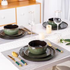 a table set for two with plates and silverware