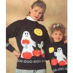 two girls wearing halloween sweaters with ghost and pumpkins on them, standing next to each other