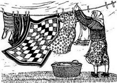 a woman hanging out her clothes on a line with laundry lines in the air and an empty basket below