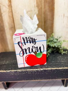 a tissue box sitting on top of a wooden table