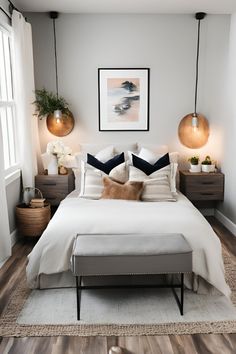 a white bed sitting in a bedroom on top of a hard wood floor