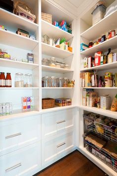 an organized pantry with white shelving and wooden floors