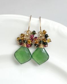 This beautiful pair features AAA Faceted Leaf-Shaped Serpentine briolettes, crowned with clusters of the most magnificent Tourmalines. Everything has been meticulously hand wrapped with 14k Gold Filled wire. Earring wires are hand forged by me, as always!  Length is approximately 1 1/2 inches. 🌿Jewelry arrives beautifully packaged in a sturdy box, wrapped with ribbon or twine. The box is perfect for gift giving or safe keeping. 🌿Please double check your name and address during checkout. Thank Handmade Tourmaline Green Earrings, Handmade Green Tourmaline Earrings, Green Tourmaline Earrings For Gift, Wire Earring, Tourmaline Earrings, Diy Earring, Earring Wires, Writing Gifts, Earring Ideas