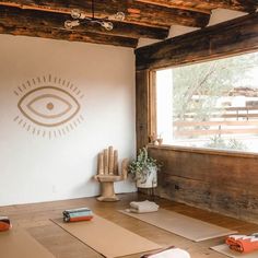 an empty room with yoga mats on the floor