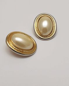 Vintage faux cream pearl clip-on earrings with gold tone metal backing, Classic costume jewelry & evening vintage jewellery Timeless classic earrings beautifully styled with a central huge cream faux pearl and gold tone metal backing. The faux pearl still has great shine and lustre which looks wonderful whether indoors or out.   Clip-on clasp mechanism is in working condition and very little wear on the gold tone and overall the earrings are ready to be worn. Undecided?... I am happy to place th Vintage Formal Clip-on Earrings With Polished Finish, Vintage Pearl Drop Clip-on Earrings, Vintage Pearl Clip-on Earrings, Vintage Pearl Clip-on Earrings For Gift, Luxury Vintage Clip-on Pearl Earrings, Classic Earrings, Pearl Cream, Vintage Clip, Timeless Classic