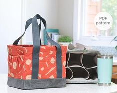 two bags sitting on top of a kitchen counter next to a coffee cup and mug