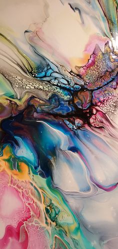 an abstract painting with multicolored fluid paint on white paper and black, blue, pink, green, yellow