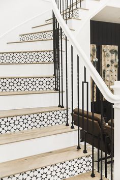 the stairs are decorated with black and white tiles