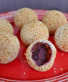 sesame seed balls are on a red plate