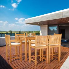 a wooden table and chairs on a deck