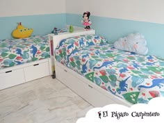 two children's beds in a room with blue walls