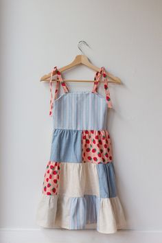 a blue and white dress hanging on a wall