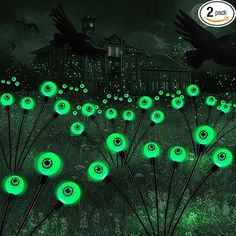 there are many green lights in the grass with birds flying above them and on the ground