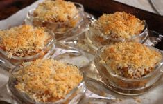 small glass dishes filled with food on top of a table