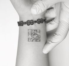 a woman's arm with a small tattoo on the left side of her wrist