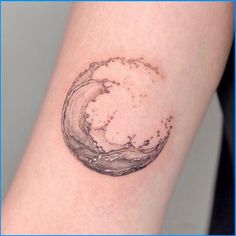 a small wave tattoo on the arm